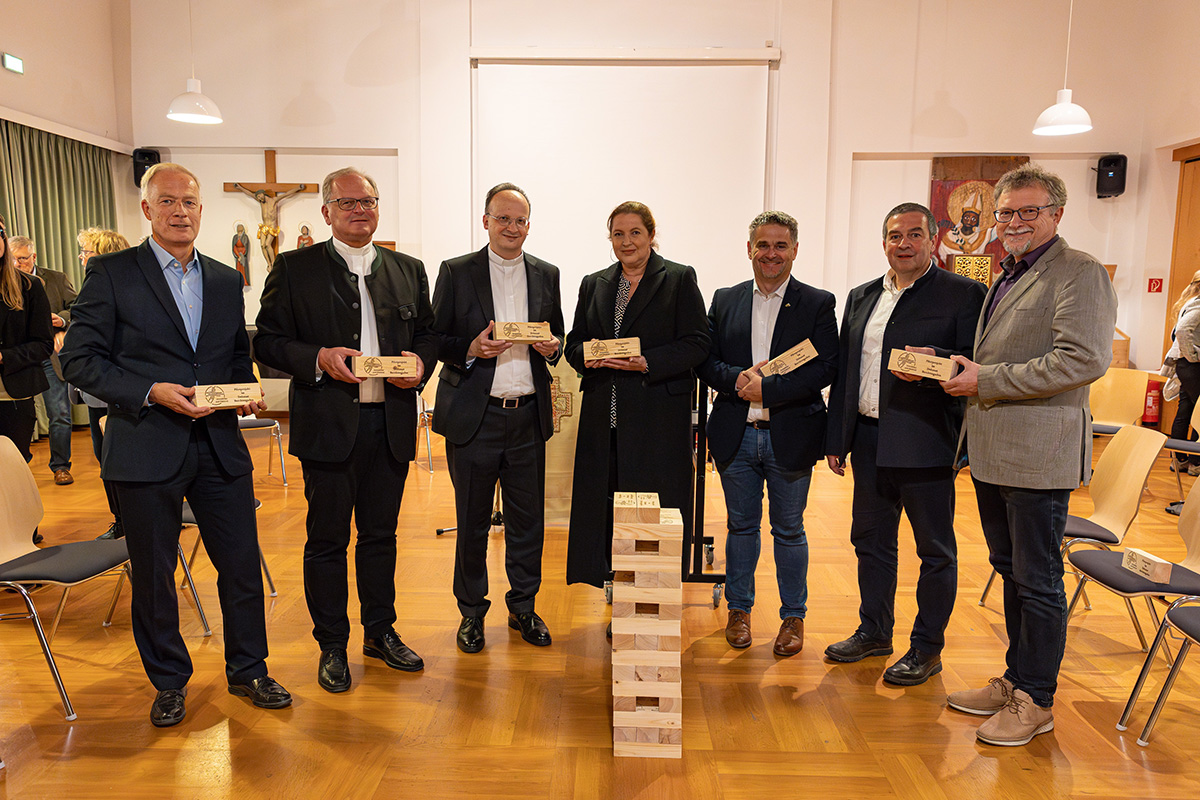 Generalvikar Christoph Klingan (3. von links), Monsignore Dr. Thomas Frauenlob, Dekan des Dekanates Berchtesgaden und Leiter des Pfarrverbandes Stiftsland Berchtesgaden sowie weitere Mitglieder des neu konstituierten Projektteams halten symbolisch Blockbausteine zum Start des Pilotprojekts in der Hand